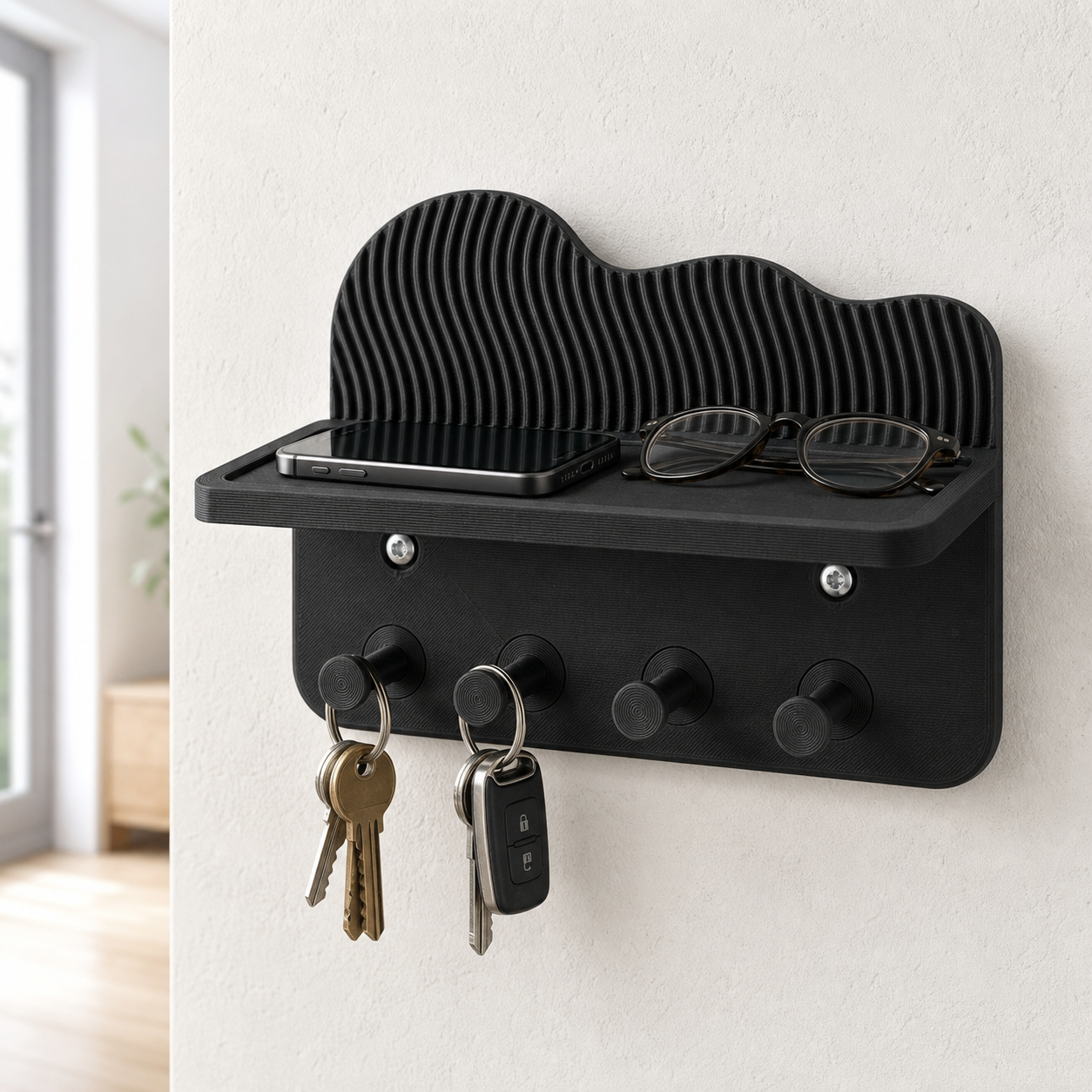 Black key holder with shelf and four hooks in a bright hallway