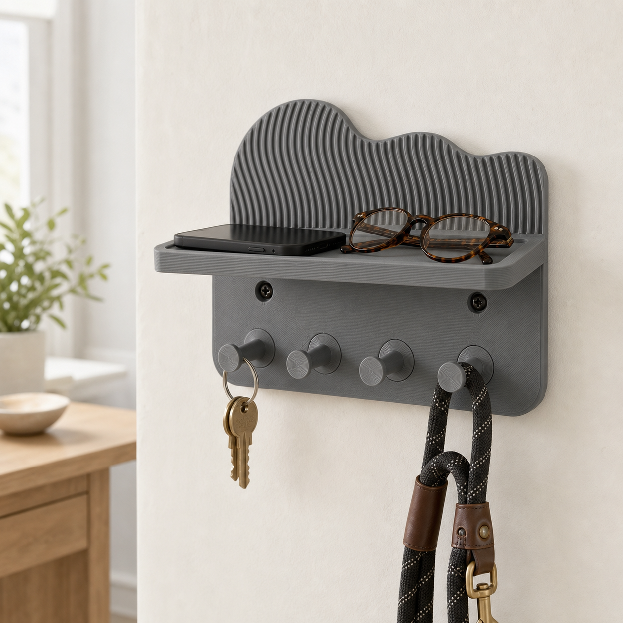 Gray key holder with shelf and four hooks in a bright hallway